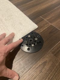 Moving a carpet from over a floor drain.
