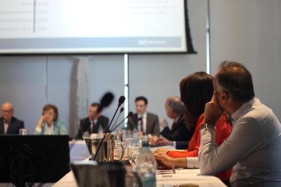 People sitting at a table talking having a formal conversation