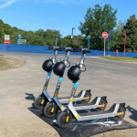 E-scooters parked at a rubber mat parking station