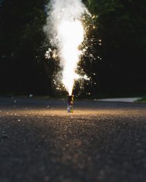 Small fireworks exploding on a street