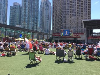 People sitting and enjoying the World Cup on Celebration Square
