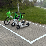 White box painted on the side walk with e-scooters parked inside it