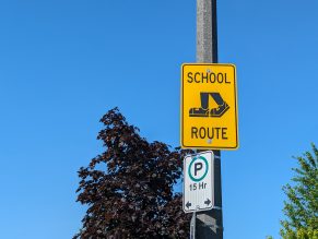 School routes sign on a pole