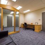 Room with desk and a couch.