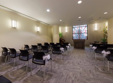 Chapel room set up with rows of chairs.