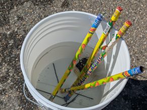 Close up of used fireworks soaking in a water bucket