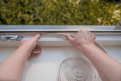 Insulation sticking sealing foam tape on indoor window.