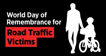 An adult accompanied by a child on a bike with text that reads World Day of Remembrance for Road Traffic Victims