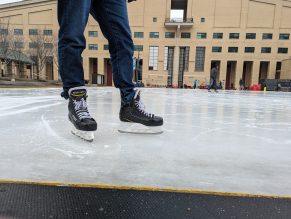 person with skates on at outdoor ice rink