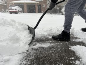 person shoveling snow on driveway