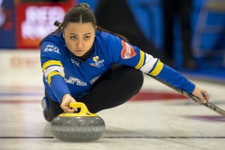 Person thrown a curling rock on a sheet.