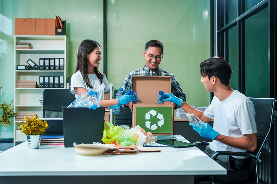 Three volunteers at a recycling centre