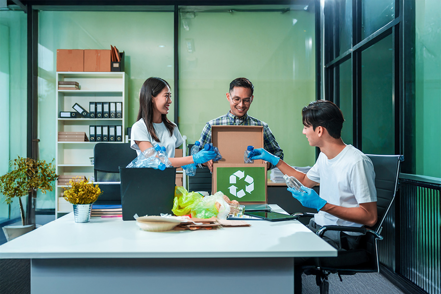Three volunteers at a recycling centre