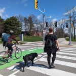 Cyclist and pedestrian crossing the street