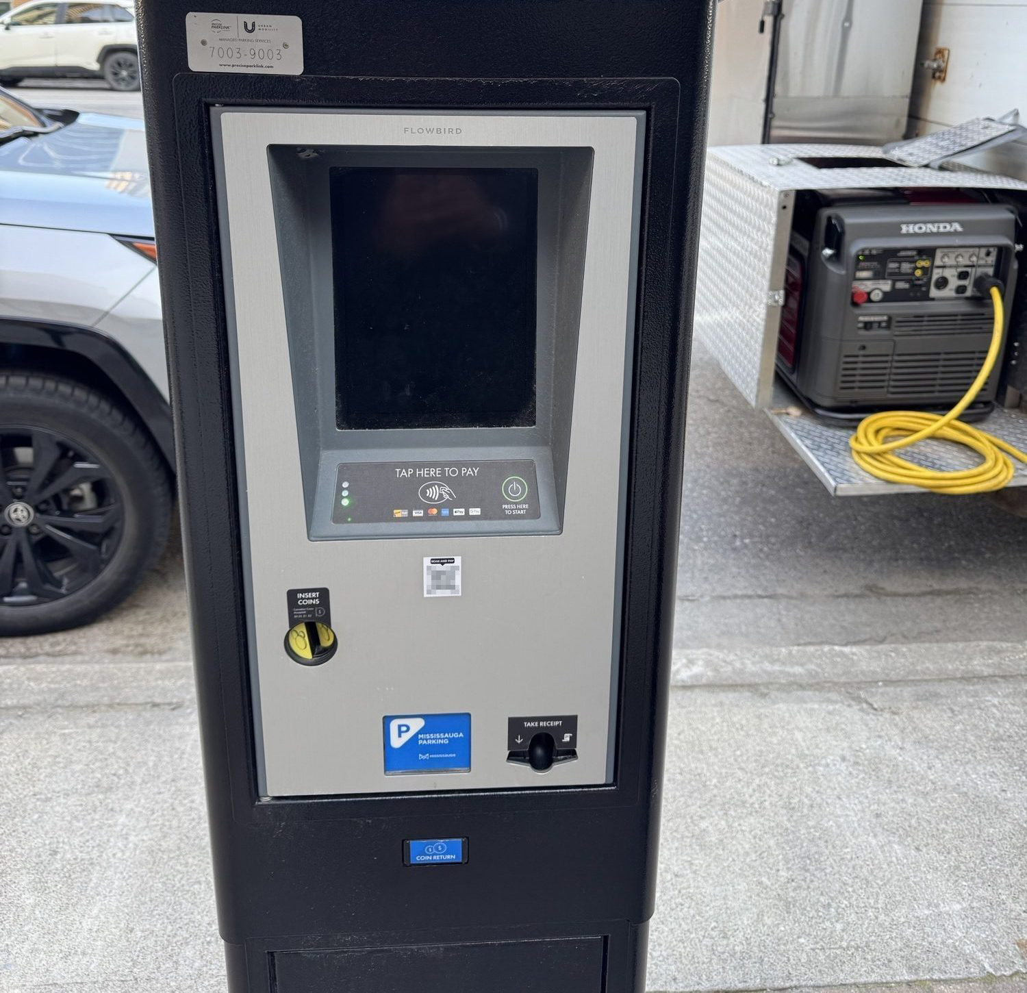City parking machine with a blurred QR code