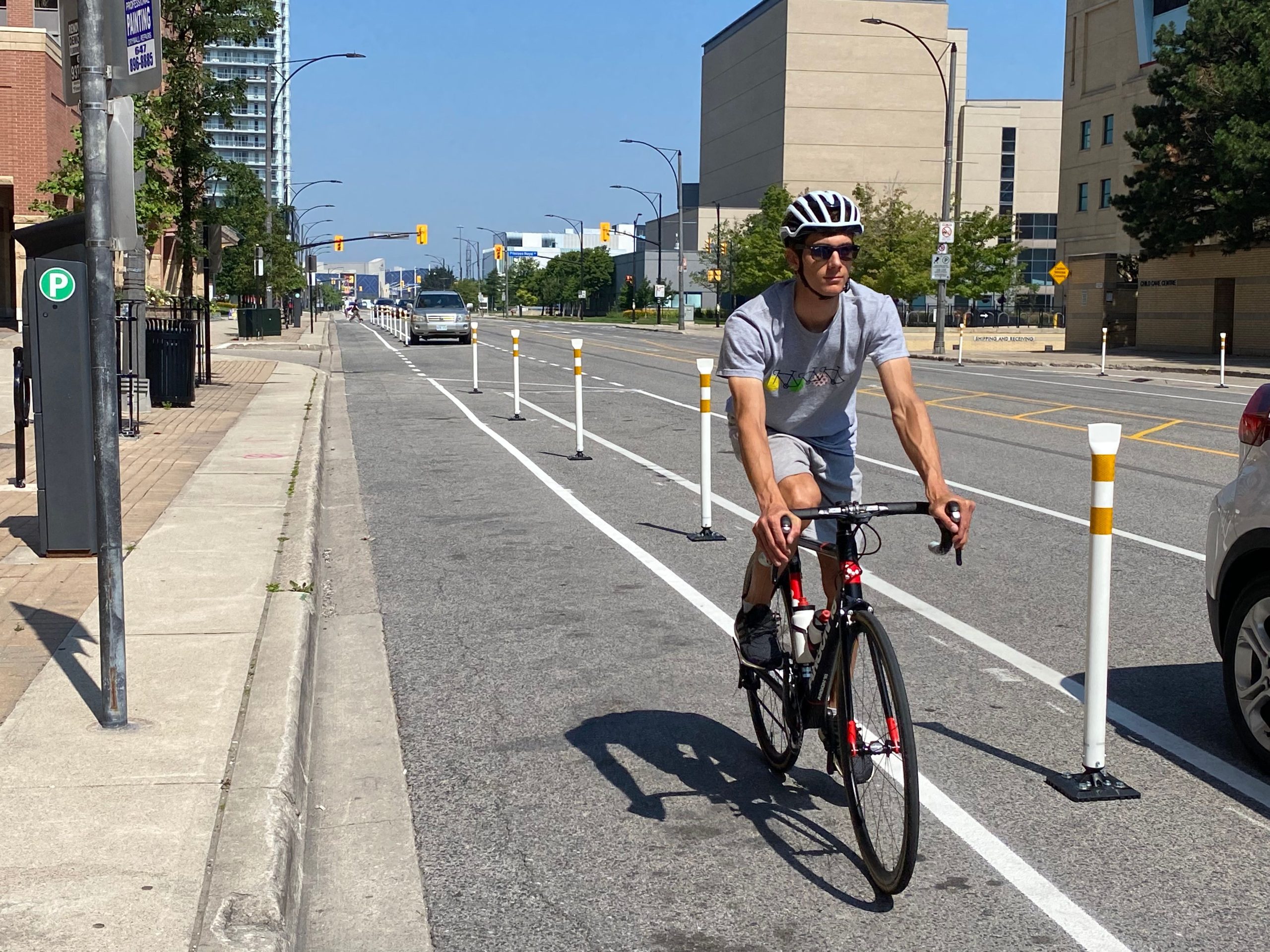 A cyclist using a protected bicycle lane