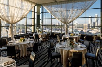 C Banquets room with tables set up and city view of downtown Mississauga.