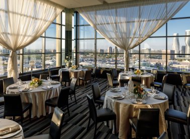 C Banquets room with tables set up and city view of downtown Mississauga.