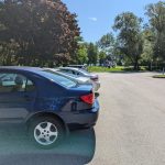 Vehicles parked in a parking lot at a park by the lakefront in Mississauga.