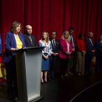 Mayor Carolyn Parrish speaking at the podium with an interpreter