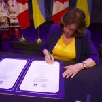 Mayor Carolyn Parrish signs the Declaration of Cooperation and Twinning.