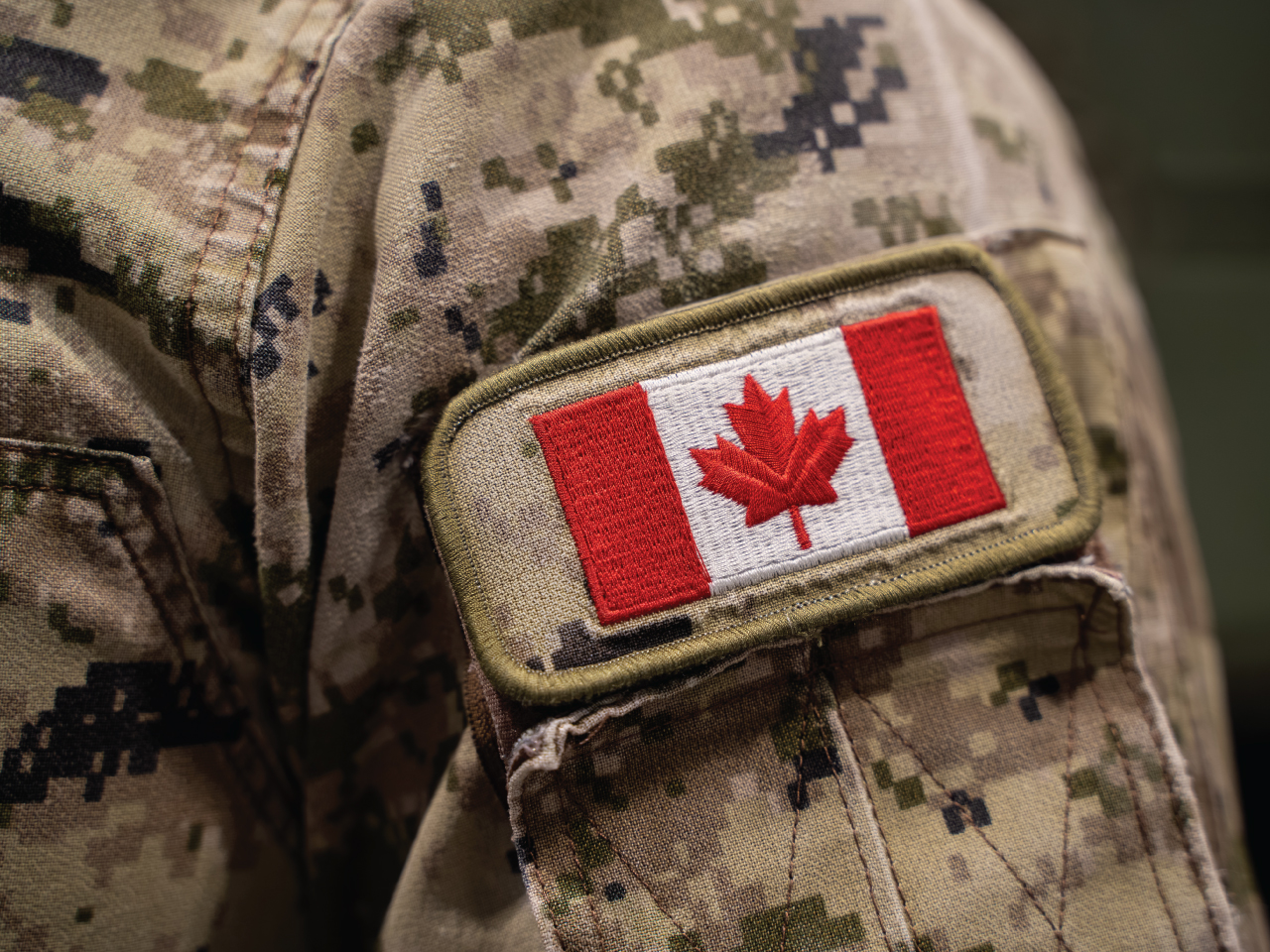 A military member's uniform with a Canada Flag