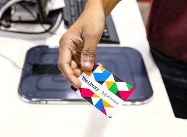 A colourful Mississauga Library card is scanned at a self-checkout station, highlighting access to library services, collections, and resources.