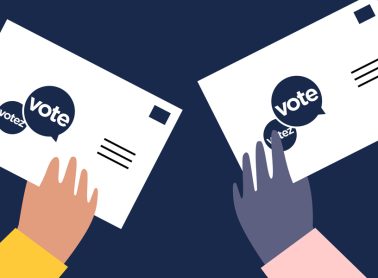 Illustration of two hands holding up cards that say 'Vote.'