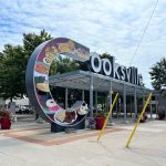 The Cooksville gateway sign at the Cooksville Corners Park. The large C holds artwork depicting various foods from the area.