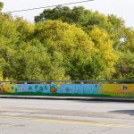 Mural painted on the retaining wall over the Cooksville Creek depicting animals and their habitats.