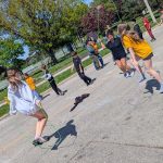 Children jump rope and play with bubbles on a road that has been closed to vehicle traffic.