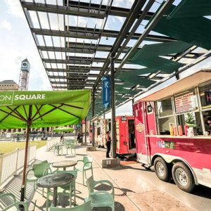 A picnic table and food trucks on Celebration Square.