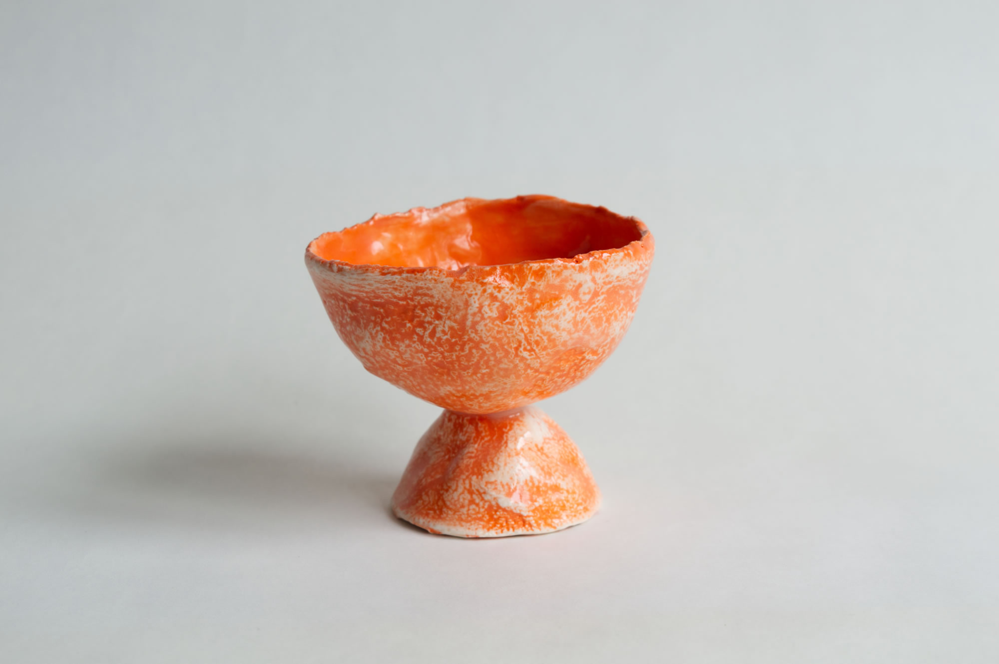 A ceramic orange cup.