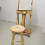Wooden easel and wooden stool.