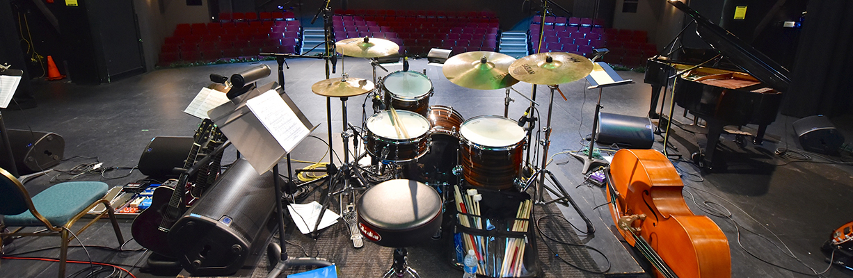 Drum kit and other instruments on a stage