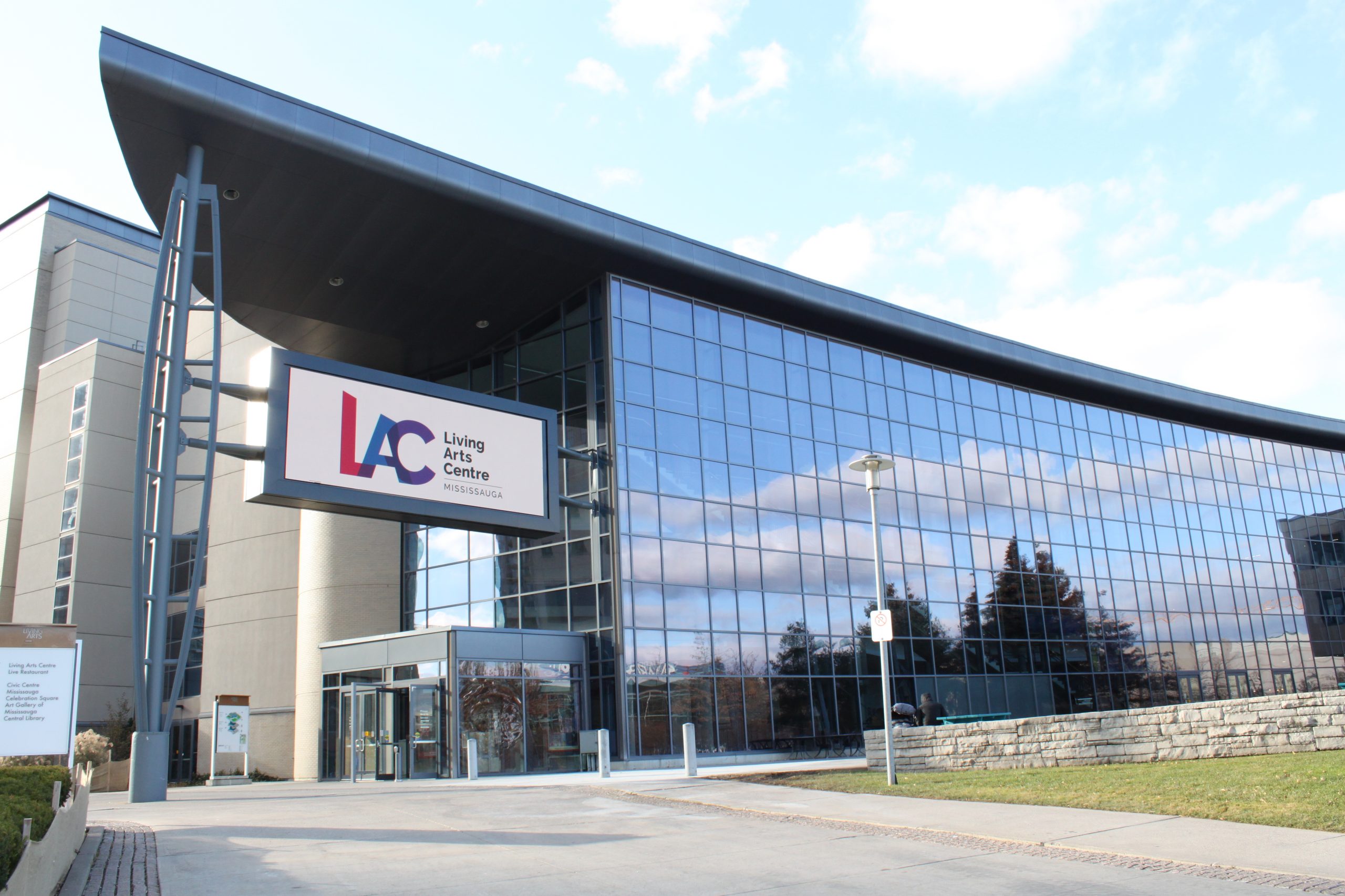 Exterior photo of the Living Arts Centre with mirrored glass and digital marquee sign Photo