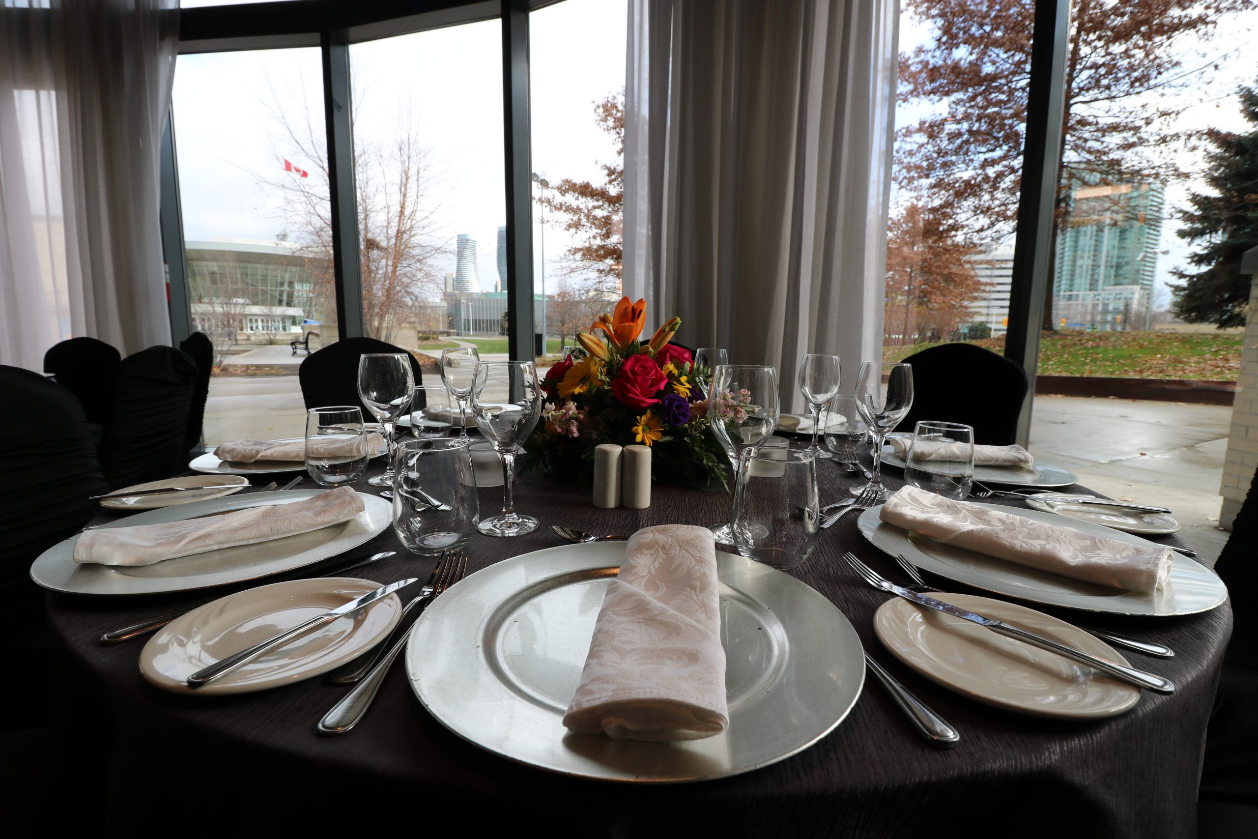 Table settings on round table with black cloth