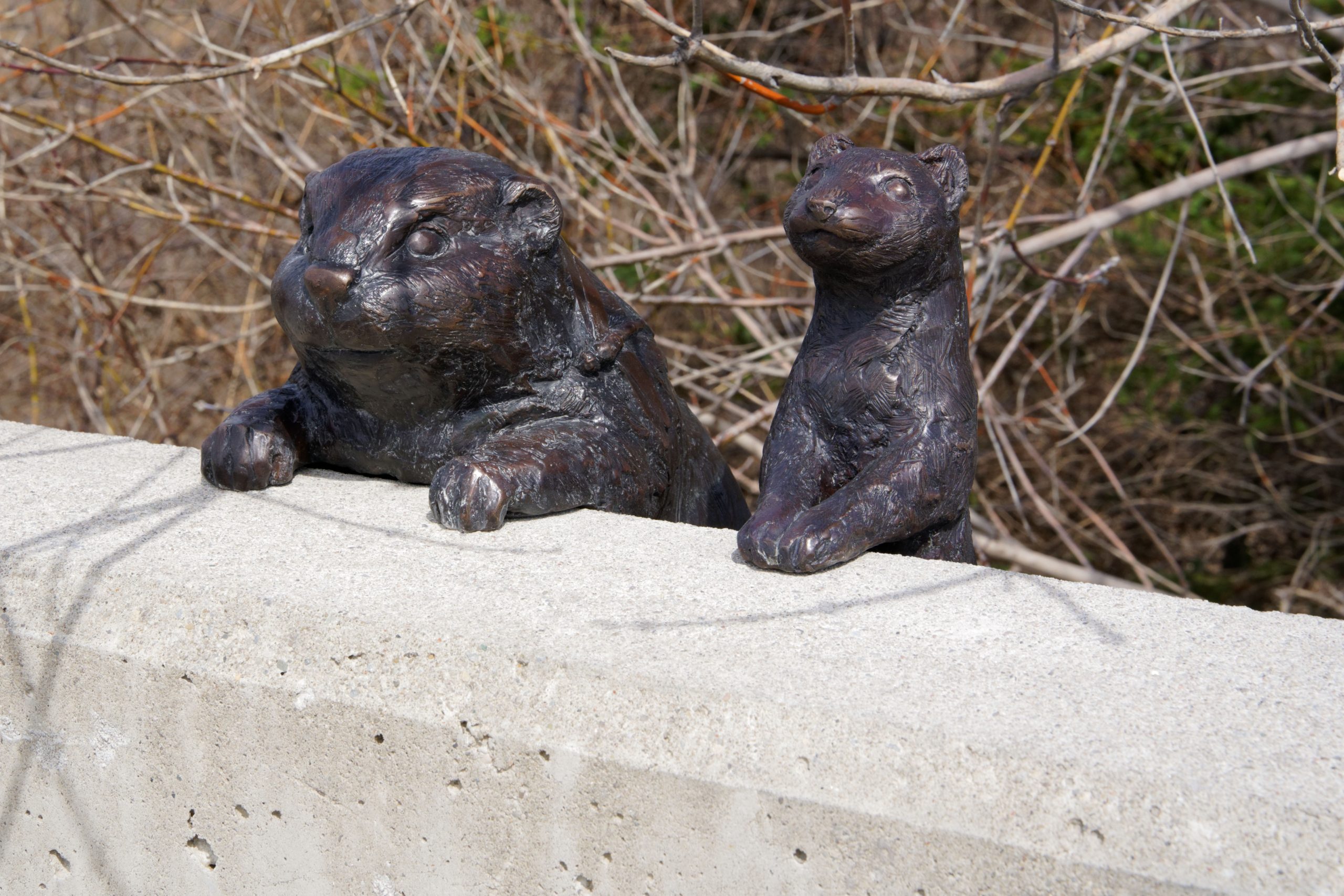 Metal sculpture depicting a beaver and otter