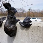 Metal sculpture depicting a rabbit and frog