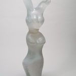 White glass sculpture of a rabbit with a female body.
