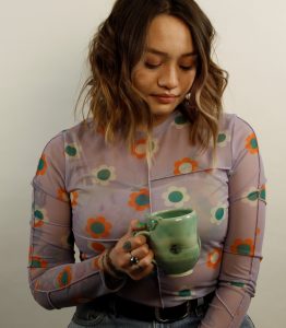 woman holding ceramic mug