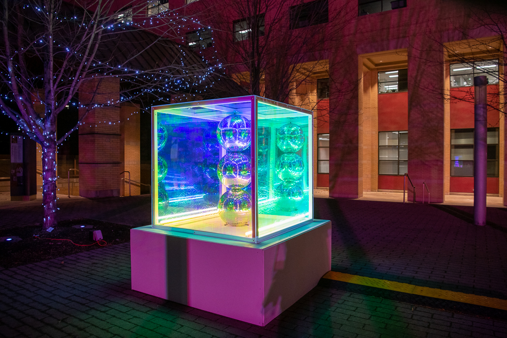 Light art sculpture with disco balls inside square box