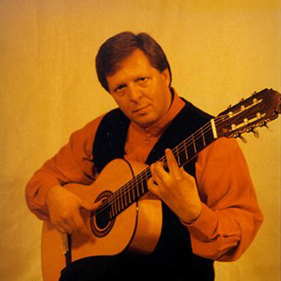 The musician BOZIDAR holding a guitar.