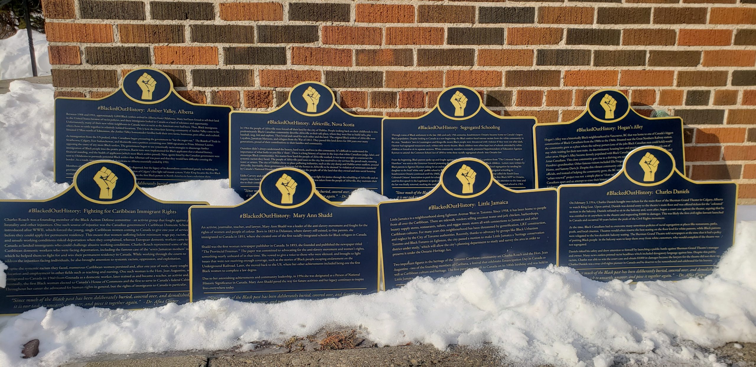 A row of historic plaques that honour Black Canadian history.