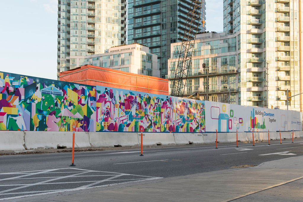 Public art mural that depicts city workers on construction hoarding.