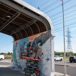 Work in progress mural development outside arena