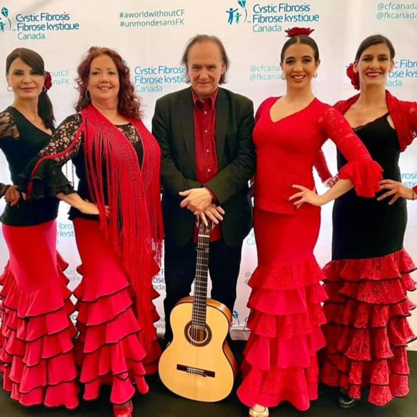 The members of Ritmo Flamenco in red and black outfits.