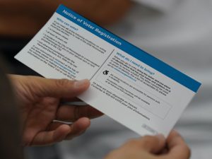 Person holding a voter notification card