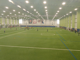 People playing soccer on indoor field