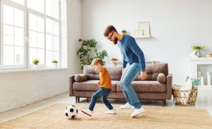 Father and son kicking a soccer ball